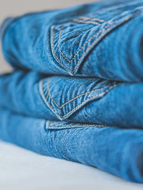 Folded mid-wash denim jeans