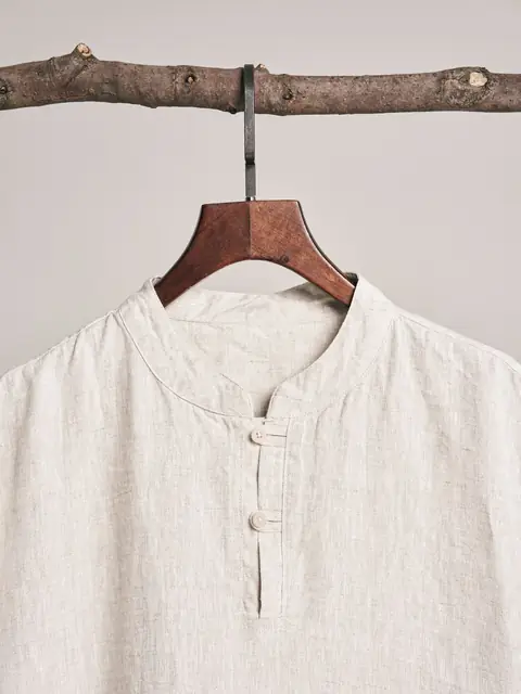 Natural linen band-collar shirt on a wooden hanger