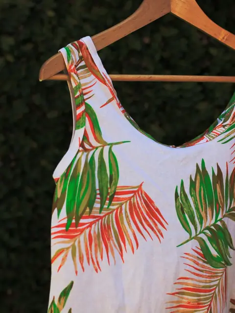 Palm-leaf print tank dress on a wooden hanger