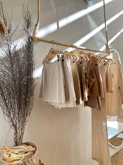 Sand and brown skirts hanging on a rail