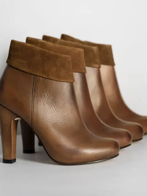 Row of cognac stacked-heel ankle boots